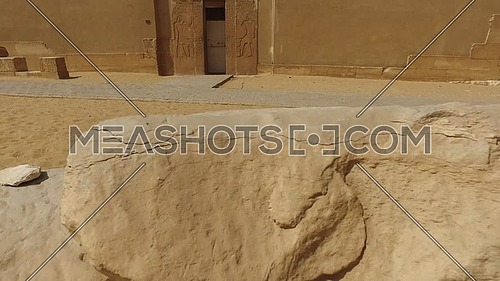 Reveal shot for an ancient Pharaonic temple door at Saqqara area at day.