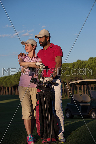 portrait of happy young  couple on golf course