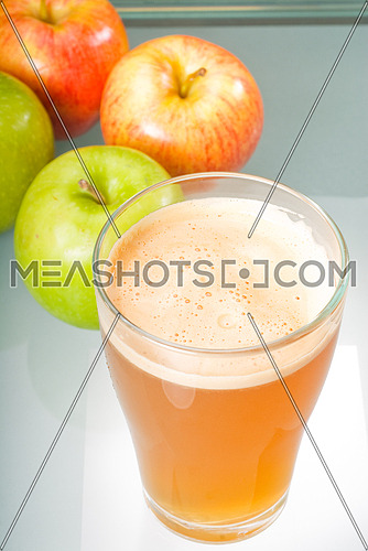 fresh  and healty natural apple  juice unfiltered , backlit on a light table