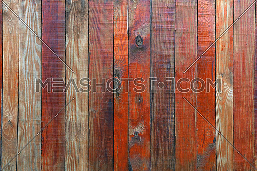 Close up background texture of red and brown weathered painted wooden planks, rustic style wall panel