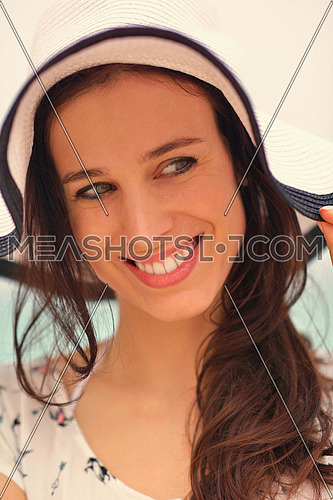 portrait of happy young woman on beach at summer vacation