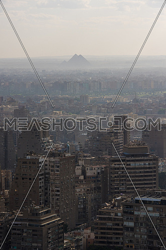 aerial view of giza city downtown with Nile and pyramids in the distance at beautiful sunny day with blue sky and clouds capital of Egypt