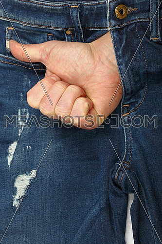 Close up man hand shows thumb up or like gesture out of open jeans fly