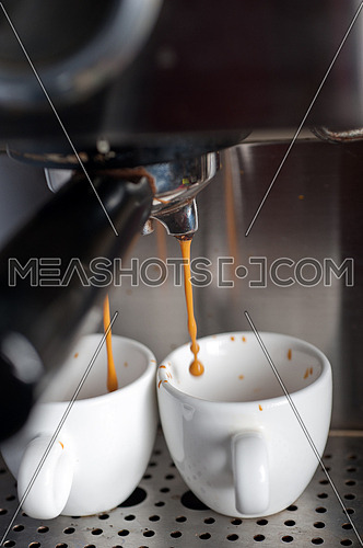 Italian espresso coffe making with professional machine macro