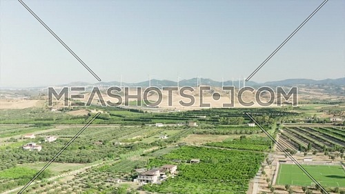 Panoramic view of the Calabria coastline, olives fields,agricultural fields and wind turbines in the background, Calabria, Italy.