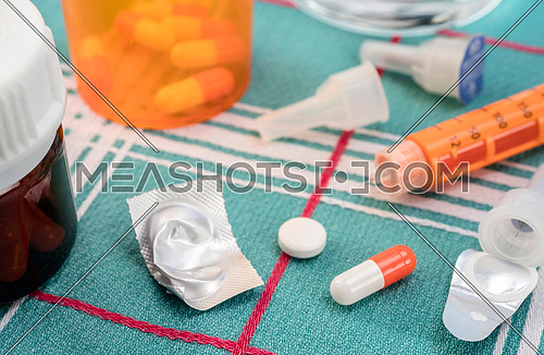 Medication during breakfast, injector of insulin together with a bottle of pills, conceptual image, composition horizontal