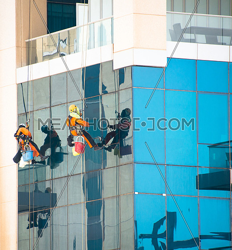 window cleaners on high skyscraper in dubai