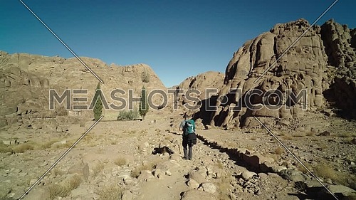 Follow shot for a male tourists exploring Sinai Mountain at day.