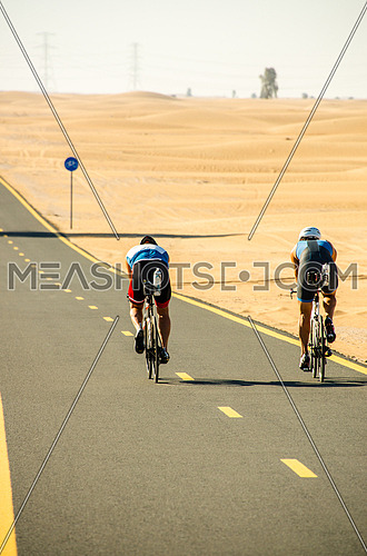 cyclist cycling on a track in the desert