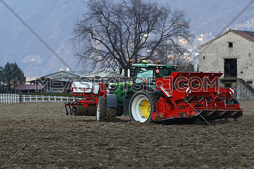 Agricultural tractor at work in a field
