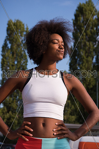 portrait of a young African American girl to run beautiful summer morning on city streets