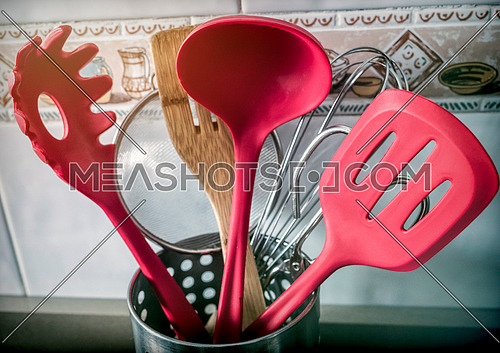 Kitchen utensils of red color in a kitchen
