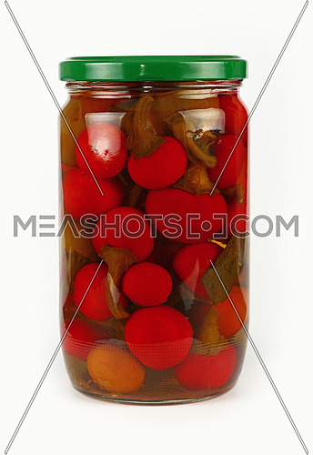 Close up of one glass jar of pickled small round red hot cherry chili peppers over white background, low angle side view