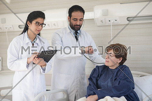 Middle eastern young doctor with nurse  and patient at hospital