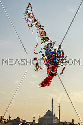 dragon shaped kite flying with background Mosque of Muhammad Ali citadel