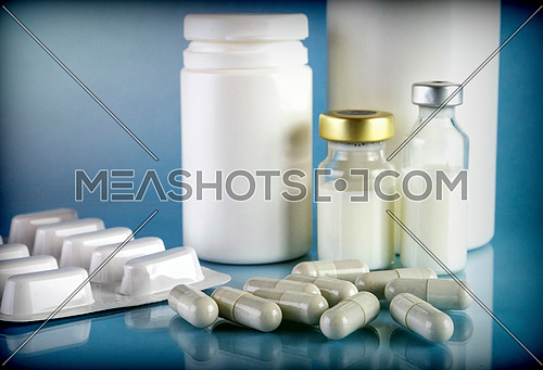Syringe vintage next to two vials with medicine isolated on white background, conceptual image