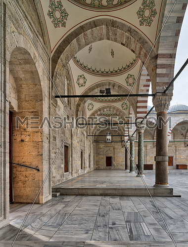 Passage leading to Fatih Mosque, a public Ottoman Baroque style mosque, with columns, arches and marble floor, Fatih district, Istanbul, Turkey