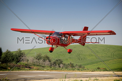 Mengibar, Jaen province, SPAIN - 8 april 2011: Las Infantas heliport where a red plane manned by student and flight instructor of a class flight practice, Jaen, Andalusia, Spain