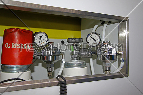 Top gages on medical oxygen tanks in a modern ambulance