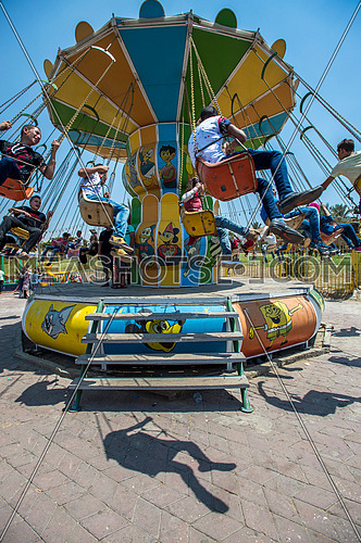 Egyptian Kids enjoying chair carousel ride  in the park during eid al fitr celebrations