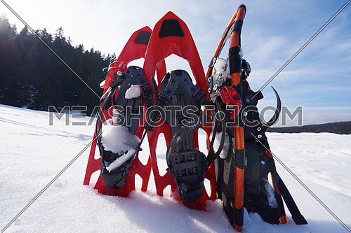 snowshoes in fresh show on beautiful winter sunny day