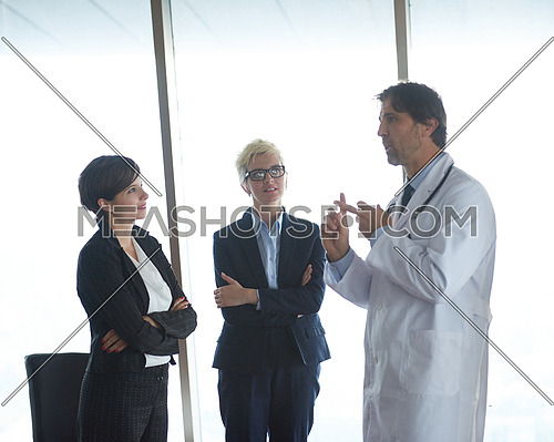 doctor with a patient family at bright modern office in hospital