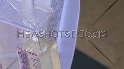 Close shot for Liquid flows into medical container