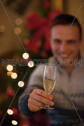 portrait of young man with champagne glass  on party celebrate christmas and new year at home