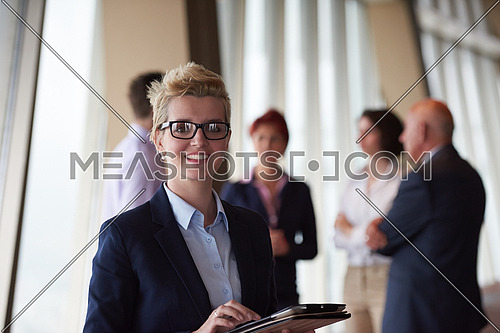 diverse startup business people group standing together as team  in modern bright office interior  with blonde  woman with glasses  in front as leader