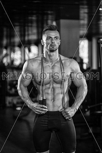 Portrait Of A Physically Fit Man Posing With Jumping Rope In Modern Fitness Center Gym