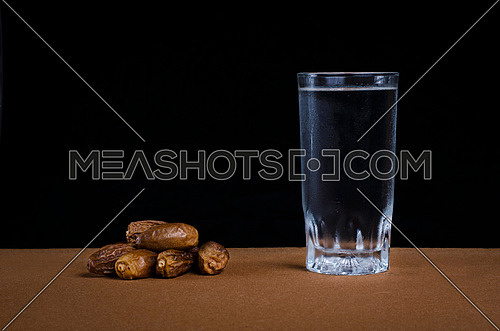 Dates and water representing breaking fast concept during holy month of ramadan