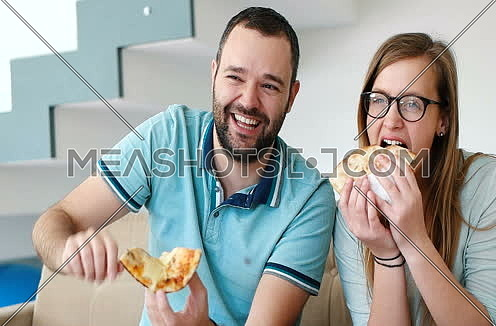 Happy Couple Eating Pizza At Home in Slow motion