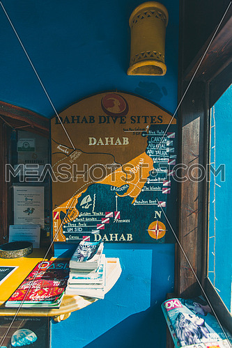 close up shot for a painted mar for the famous diving spots of Dahab hanged to wall at day.