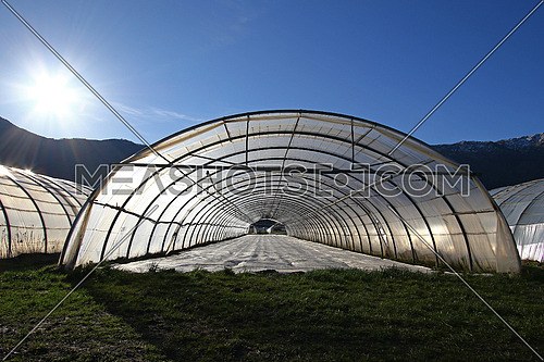 Sun above freshly planted greenhouse