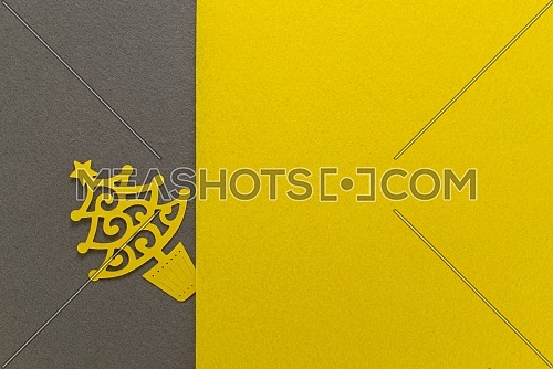 Postcard with paper cut Christmas tree on grey yellow background. Demonstrating trendy color of the year 2021. Illuminating yellow and ultimate gray