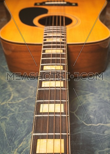 acoustic guitar on green marble background,music concept.