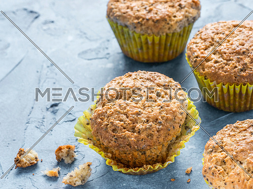 Muffins with chia seeds. Homemade muffin on blue concrete textured background