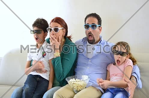 middle eastern family watching 3d content at home livingroom