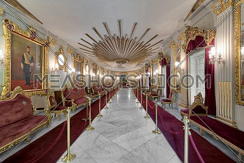 Throne Hall at Manial Palace of Prince Mohammed Ali Tewfik with ornate ceiling inspired by the old flag of the ottoman empire, gold plated armchairs, and red carpets, Cairo, Egypt