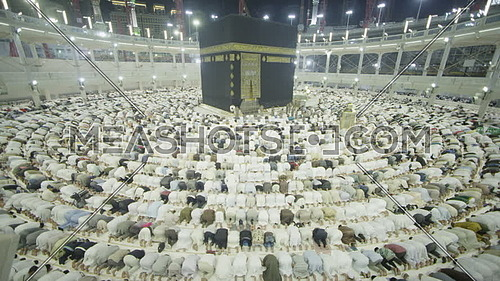 Muslim People kneeling in pray at Kaaba for Pilgrimage.