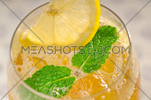 refreshing Ice tea closeup macro with lemon and mint leaves