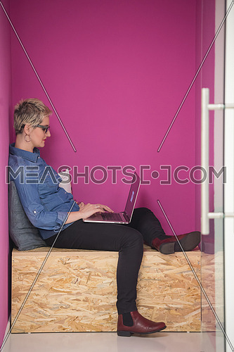 young woman in crative box working on laptop computer, startup business modern office room  interior