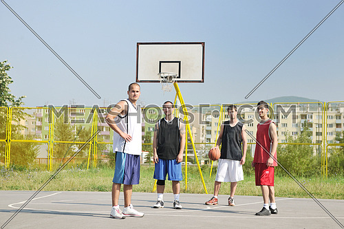basketball player team group  posing on streetbal court at the city on early morning