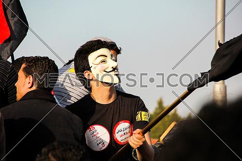 A man wearing anonymous mask in a protest