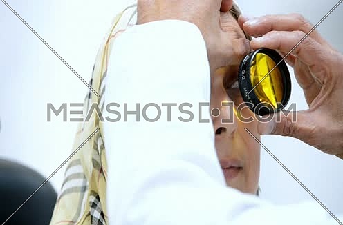 middle eastern senior ophthalmologist checking patient eyes