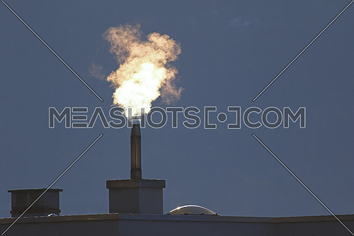 Heating oil going into the air from a filtered stack on a roof