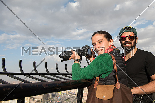 happy tourists taking photos from cairo tower at beautiful sunny day