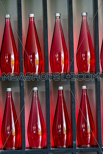 abstract background of decorative bottles of red juice in modern restaurant