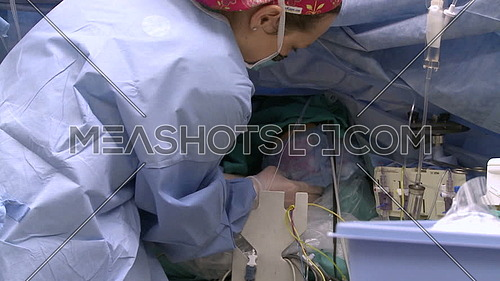 Close shot for nurse applying Ice packs to heart patient 