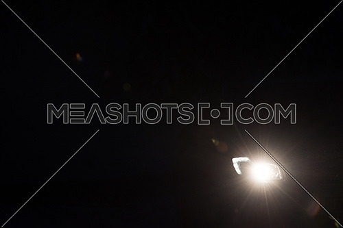 driving car in night,  modern front lights lens flare in black background